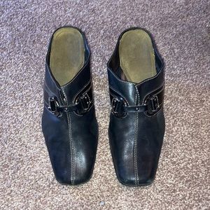 Brown Heel clogs with hill and silver buckle in front,